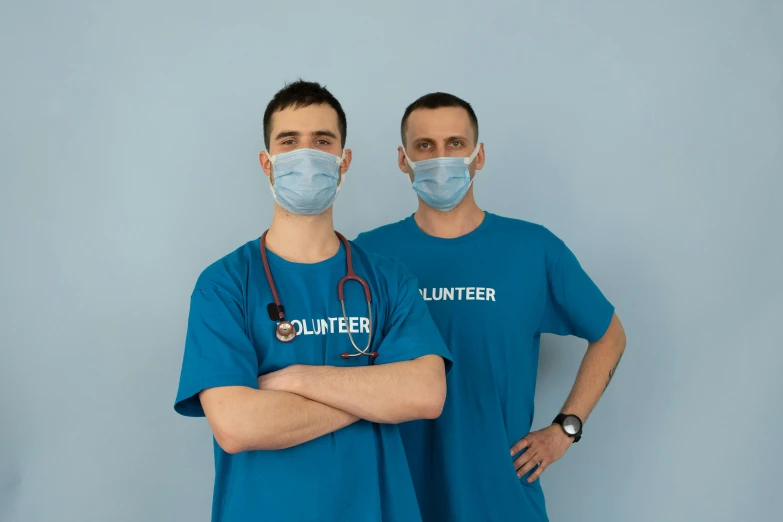 a couple of men standing next to each other, by Emma Andijewska, pexels contest winner, hurufiyya, nurse scrubs, avatar image, studio photo, thumbnail