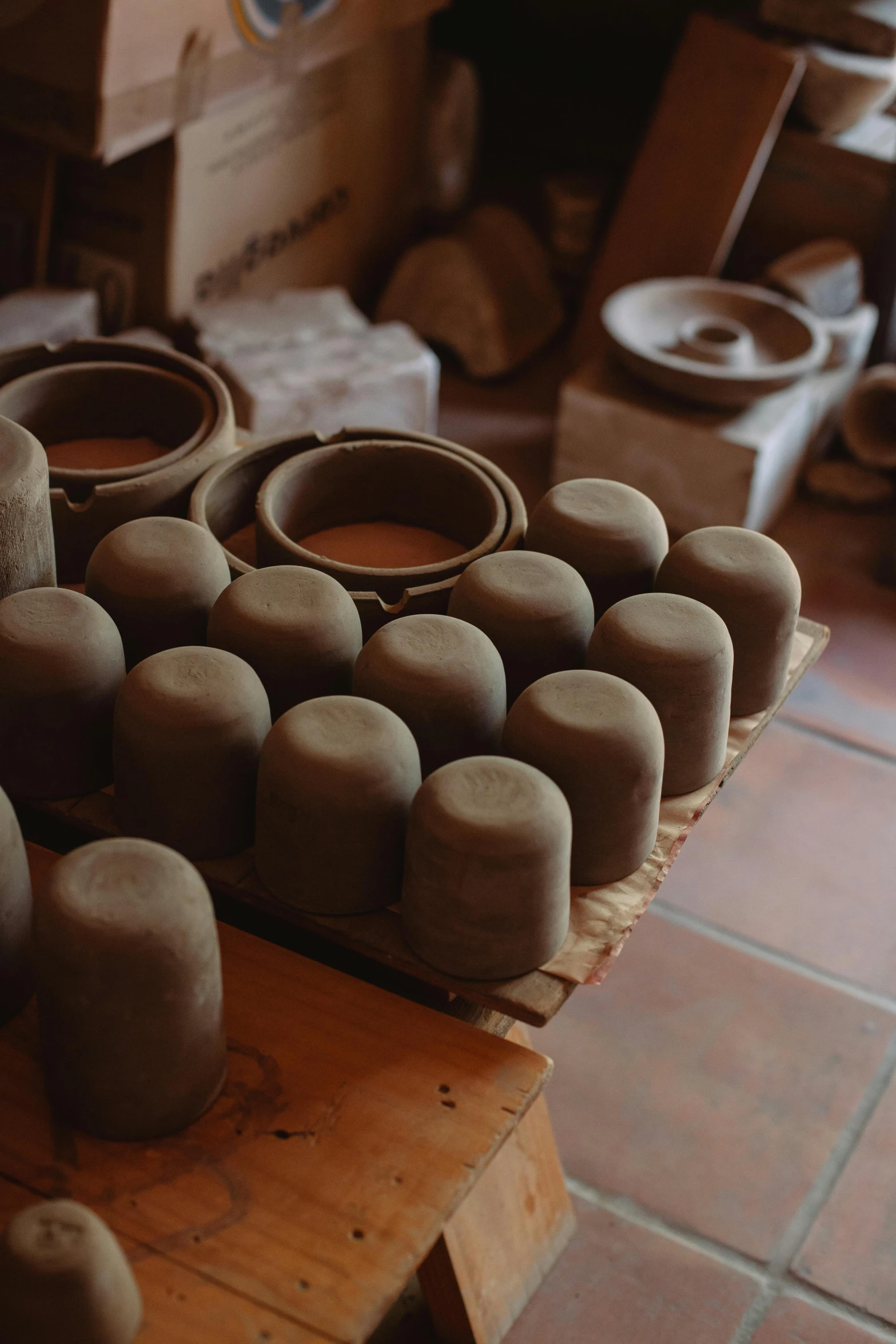 a pile of pottery sitting on top of a wooden table