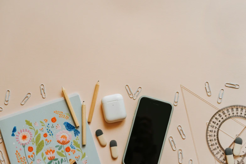 a cell phone sitting on top of a desk, by Carey Morris, trending on pexels, pastel color theme, knolling, background image, full body image