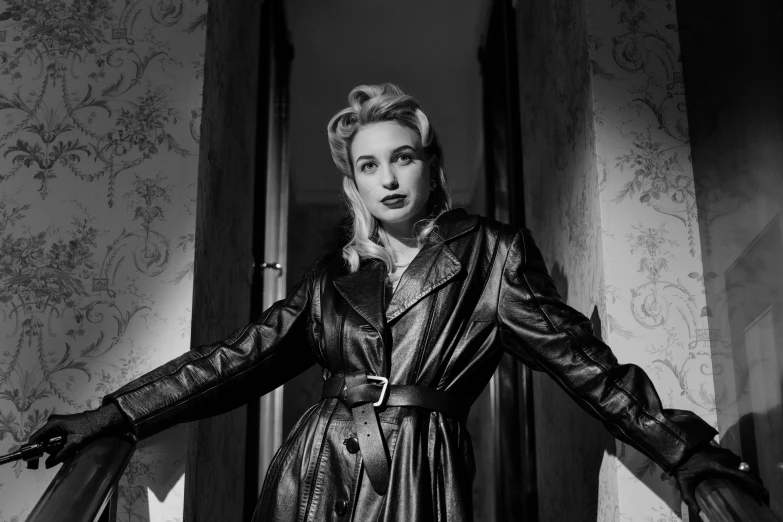 a black and white photo of a woman in a leather coat, inspired by George Hurrell, pexels, young dolly parton, 5 0 s aesthetic, sardax, cinematic outfit photo