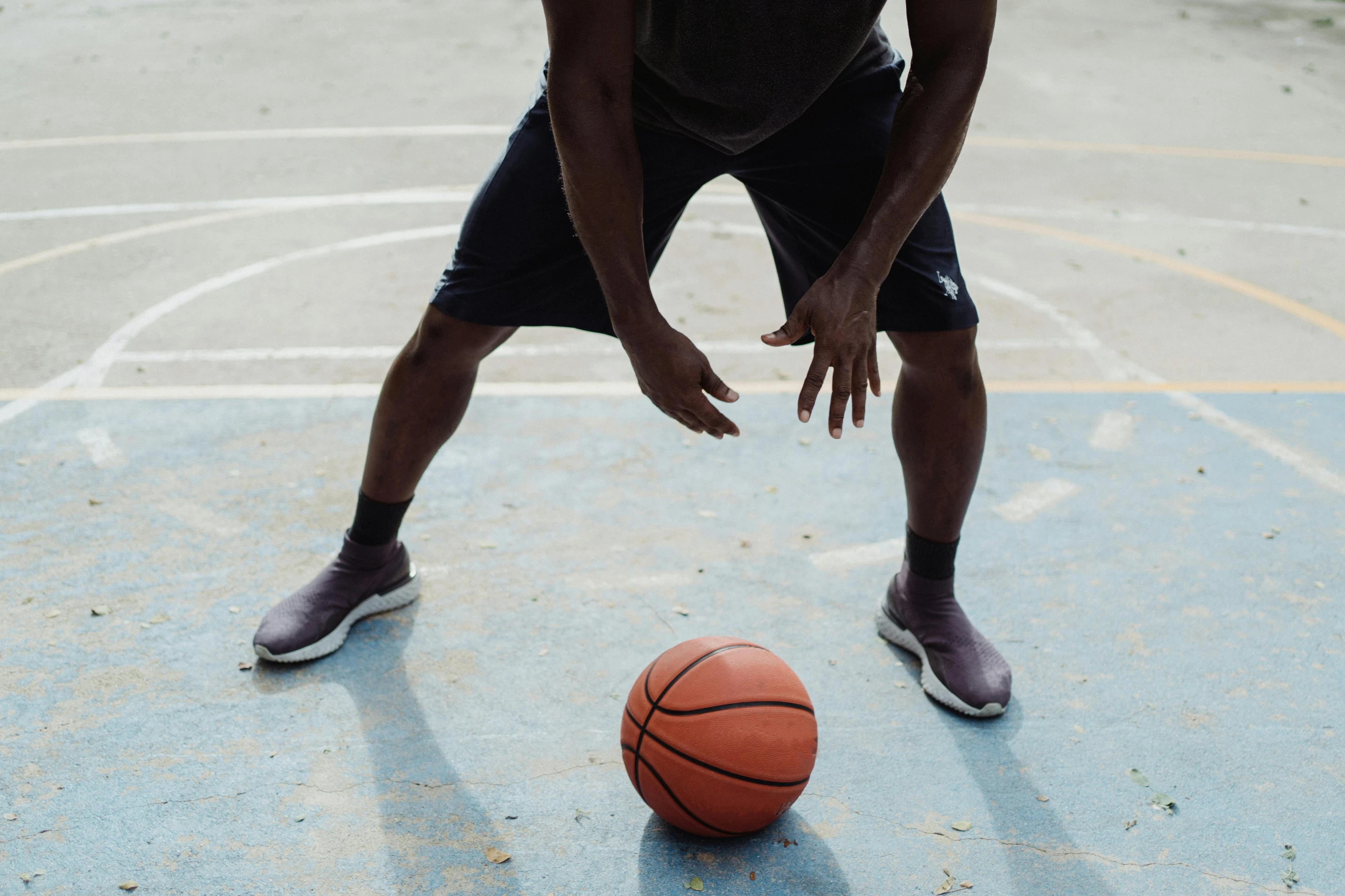 a man dribbling a basketball on a basketball court, by Carey Morris, trending on dribble, round thighs, 15081959 21121991 01012000 4k, on the concrete ground, jaylen brown