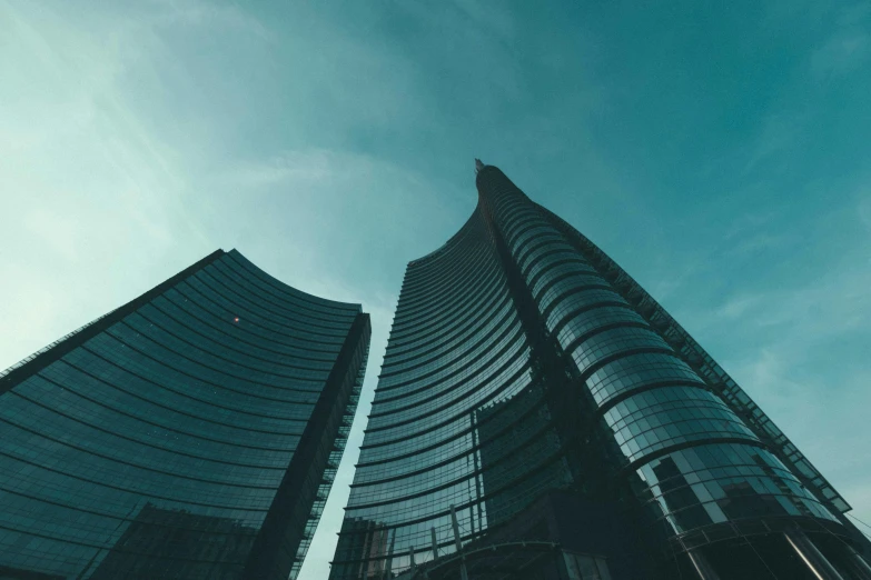 a couple of tall buildings sitting next to each other, a picture, pexels contest winner, milan jozing, curvy build, three towers, **cinematic