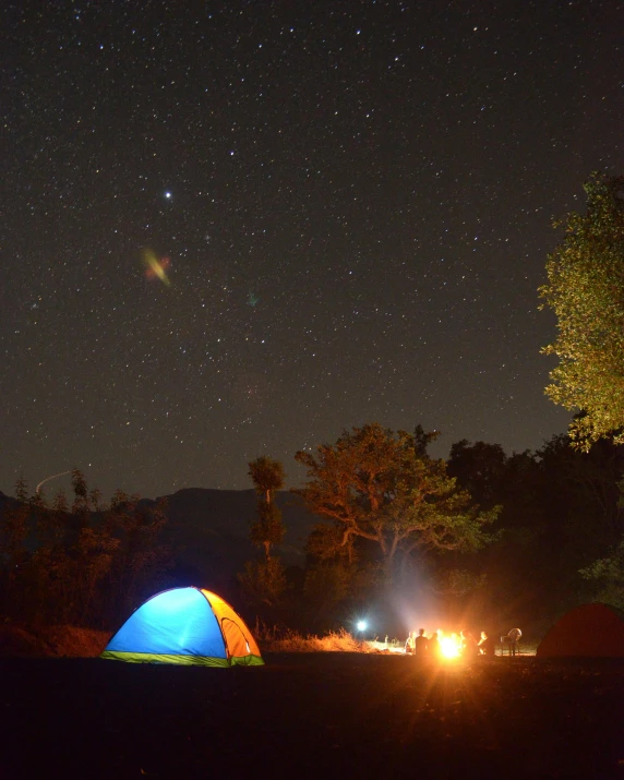 a couple of tents that are in the grass, unsplash contest winner, hurufiyya, small reflecting rainbow stars, uttarakhand, profile image, campfire