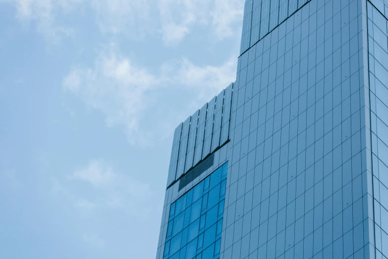 a clock that is on the side of a building, by Adam Marczyński, pexels contest winner, minimalism, sky blue, executive industry banner, square lines, towering high up over your view