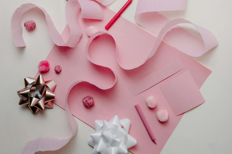 a pink piece of paper sitting on top of a table, various items, bows, thumbnail, gourmet and crafts