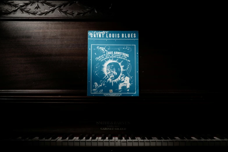 a book sitting on top of a piano, blues, detailed cover artwork, loftis, saint