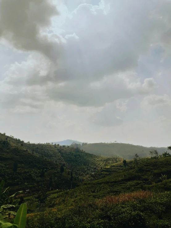 a view from the top of a hill on a cloudy day, an album cover, unsplash contest winner, sumatraism, sri lankan landscape, photo on iphone, overcast!!!, afternoon sunlight