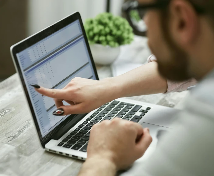 a man sitting at a table using a laptop computer, trending on pexels, email, excel running on the computer, official screenshot, maintenance photo