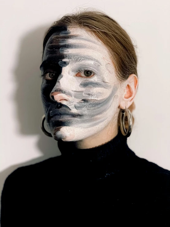 a woman with white paint on her face, inspired by Anna Füssli, reddit, photography of charline von heyl, stripe over eye, gray anthropomorphic, black facemask