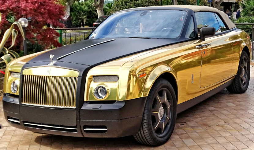 a gold rolls royce parked in a driveway, a portrait, pixabay, gold bodypaint, gold gates of heaven!!!!!!!!, glass and metal : : peugot onyx, square