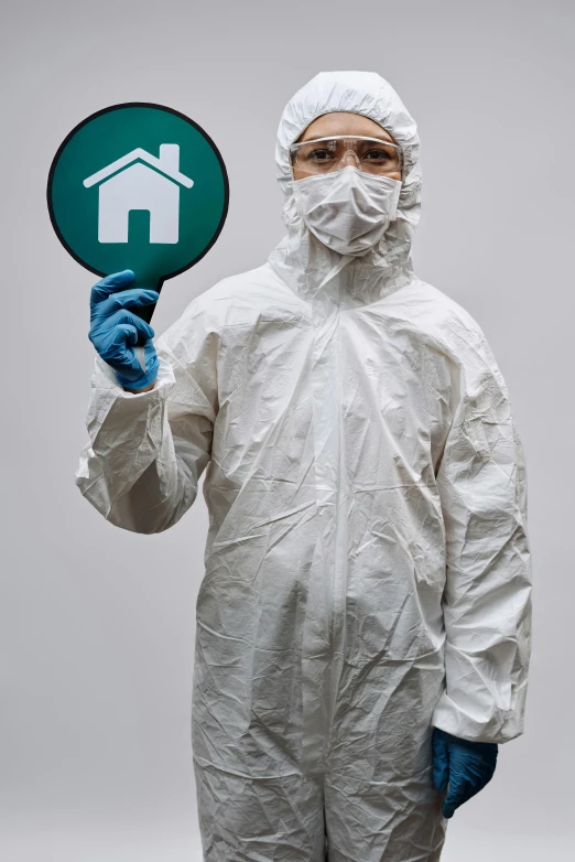 a man in a protective suit holding a sign, shutterstock, renaissance, house and home, white and teal garment, all enclosed in a circle, clean medical environment