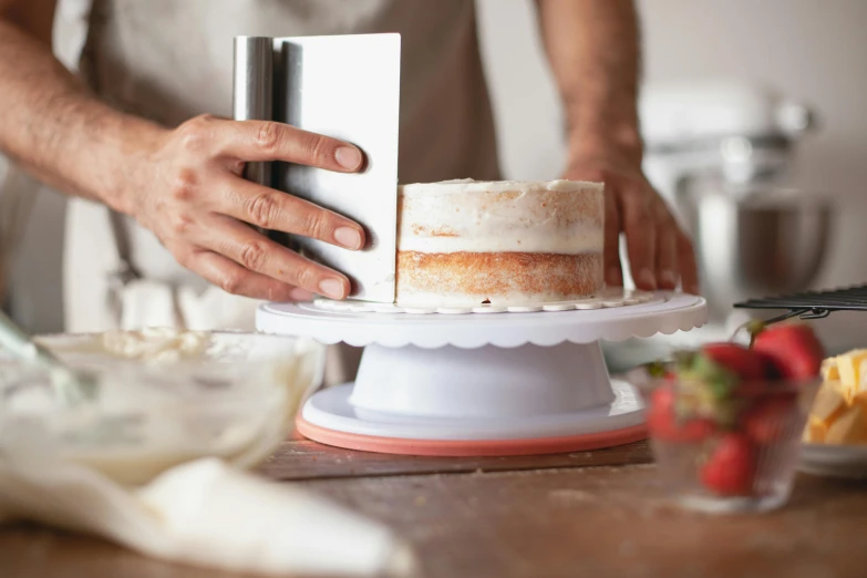 a person that is cutting a cake on a table, textured base ; product photos, holding a tower shield, recipe, back towards camera