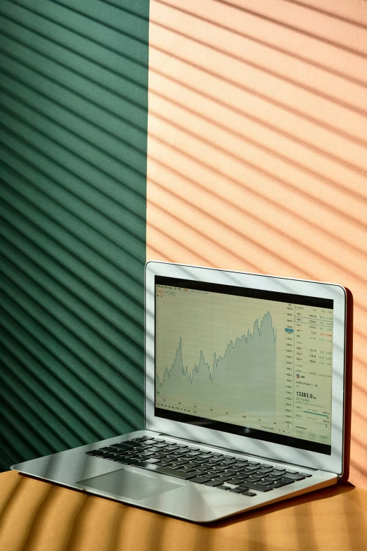 a laptop computer sitting on top of a wooden table, by Carey Morris, trending on unsplash, computer art, green charts, vertical lines, crypto, 15081959 21121991 01012000 4k