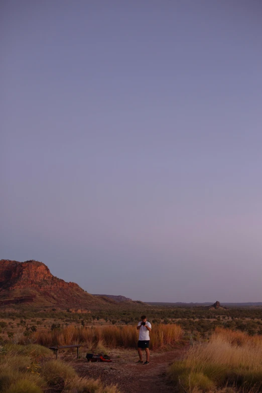 a person is flying a kite in the desert, australian tonalism, last photo ever taken, big moon on the right, cowboy, belle