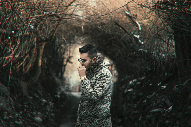 a man standing in a tunnel talking on a cell phone, a picture, inspired by Elsa Bleda, pexels contest winner, singer maluma, in woods, cold shades, instagram post 4k