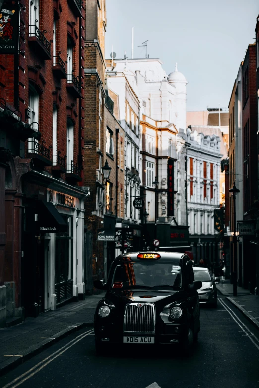 a car driving down a street next to tall buildings, pexels contest winner, baroque, nineteenth century london, black, a quaint, taxis