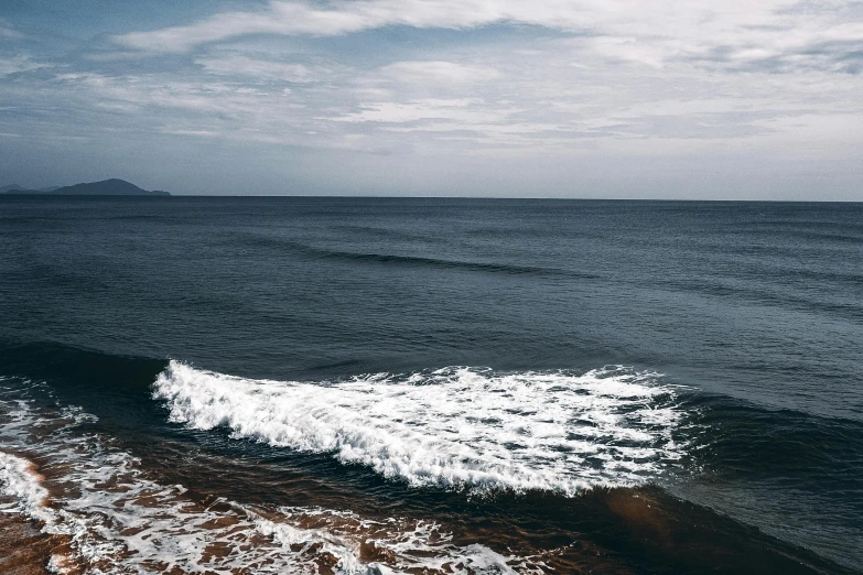 a person riding a surfboard on top of a wave, pexels contest winner, minimalism, ocean shoreline on the horizon, an eerie whirlpool, dark blue water, puerto rico