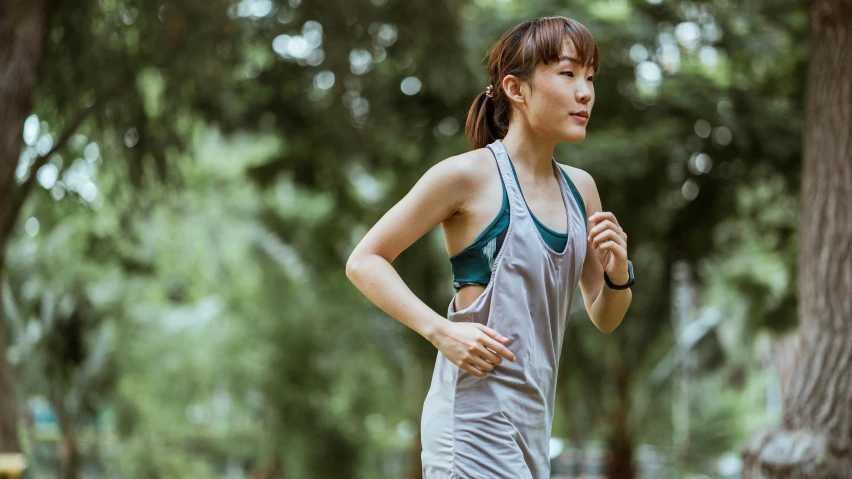 a woman running in a park with trees in the background, shin hanga, wearing : tanktop, profile image, gray, lifestyle