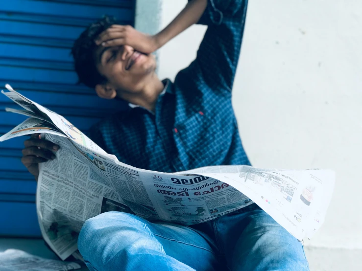 a man sitting on the ground reading a newspaper, pexels contest winner, happening, sassy pose, jayison devadas, avatar image, happily tired