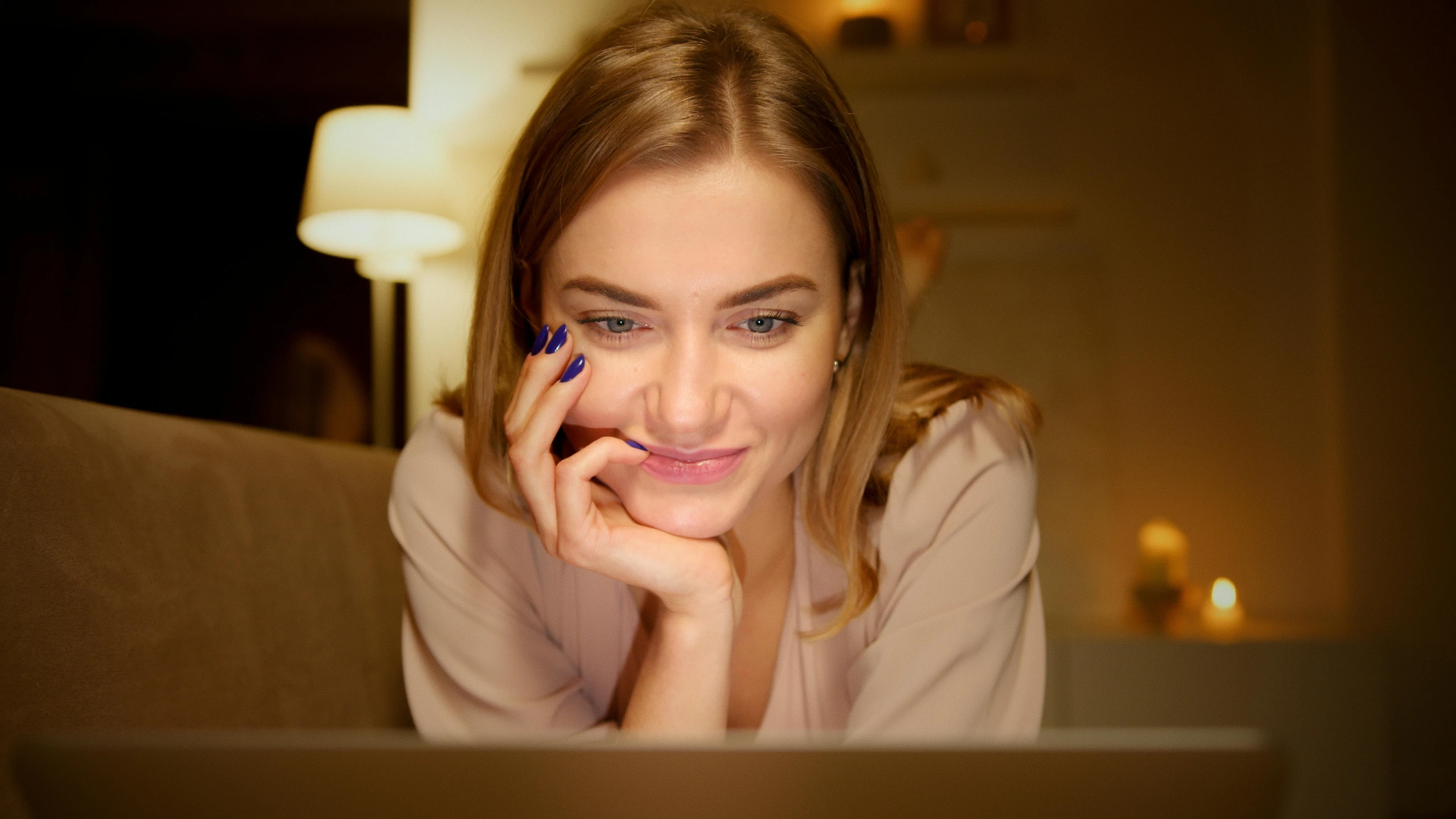 a woman laying on a couch in front of a laptop, a portrait, by Adam Marczyński, trending on pexels, renaissance, close up of a blonde woman, lights on, brown, close up to the screen