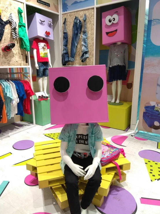 a person sitting on a bench with a box on their head, inspired by Hikari Shimoda, featured on instagram, neo-dada, in a mall, cardboard cutout, finn from adventure time, with fashion clothe