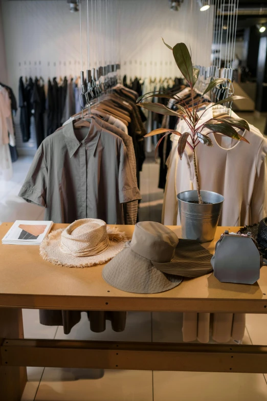 a wooden table topped with lots of clothes, bucket hat, product display, thumbnail, modern earthy neutral earthy