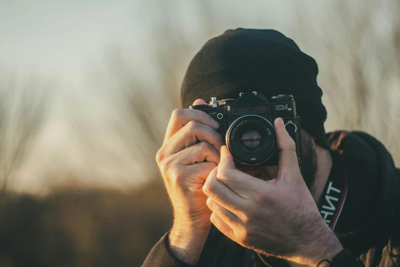 a man taking a picture with a camera, a picture, pexels contest winner, action photograph, tight shot of subject, shot from a distance, lovingly looking at camera