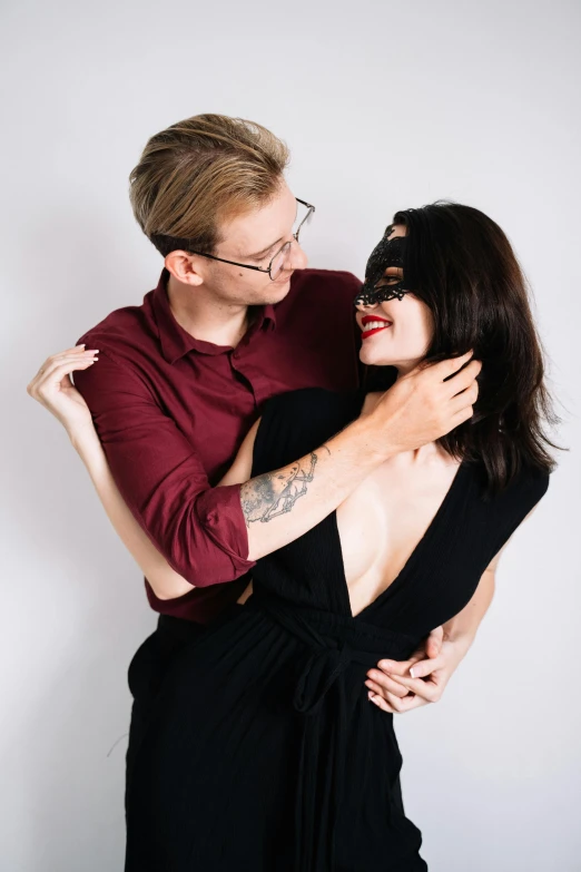 a woman in a black dress hugging a man in a red shirt, reddit, antipodeans, mask off, non binary model, profile image, wearing black glasses