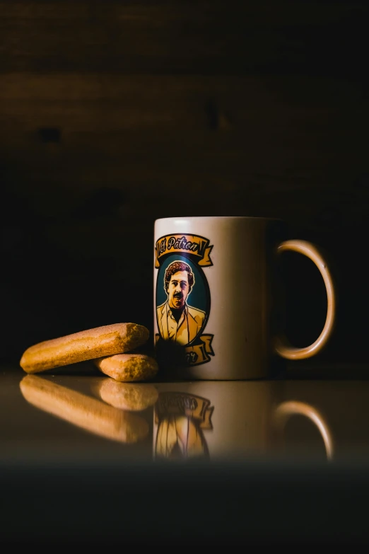 a coffee mug sitting on top of a table, a portrait, inspired by Wes Anderson, pexels, pop art, cigar, snacks, al pacino, ned flanders