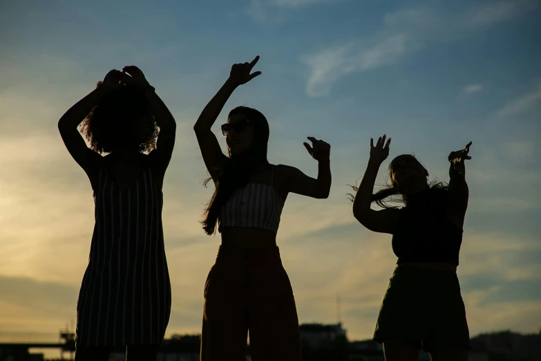 a group of three women standing next to each other, by Attila Meszlenyi, trending on pexels, happening, dance party, skies behind, silhuette, 15081959 21121991 01012000 4k