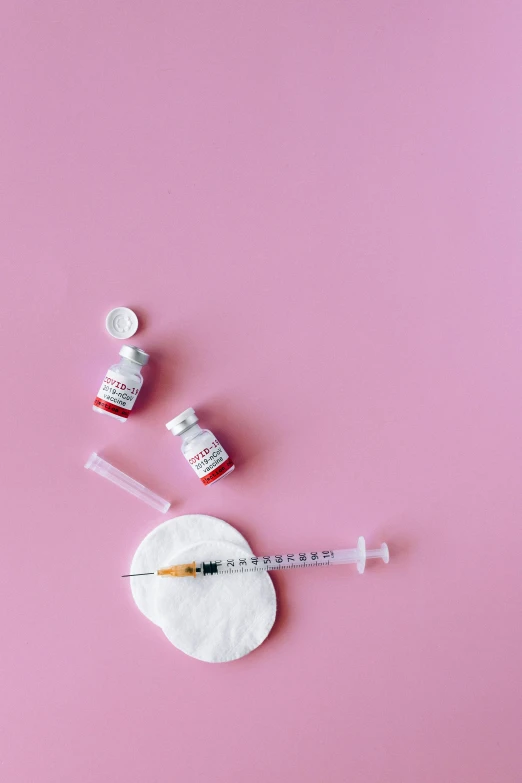 a syll, a syll and a syll on a pink background, by Julia Pishtar, trending on pexels, holding syringe, white and red color scheme, steroid use, flatlay