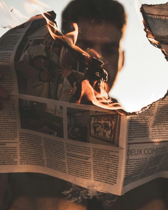 a man reading a newspaper with fire coming out of it, a picture, pexels contest winner, deconstructivism, ripped fabric, cutout, selfie photo, lgbtq