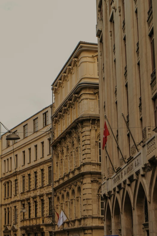 a group of people walking down a street next to tall buildings, renaissance, austrian architecture, profile image, gold and red, banner