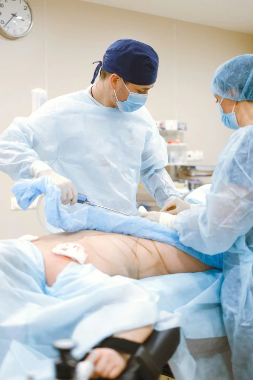 a group of doctors performing surgery on a patient, by Dan Content, shutterstock, stomach skin, 2506921471, instagram post, thigh skin