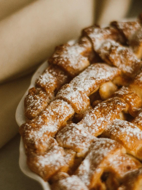 a pie sitting on top of a table covered in powdered sugar, by Matija Jama, unsplash, 2 5 6 x 2 5 6 pixels, apple pie, pasta, close-up!!!!!