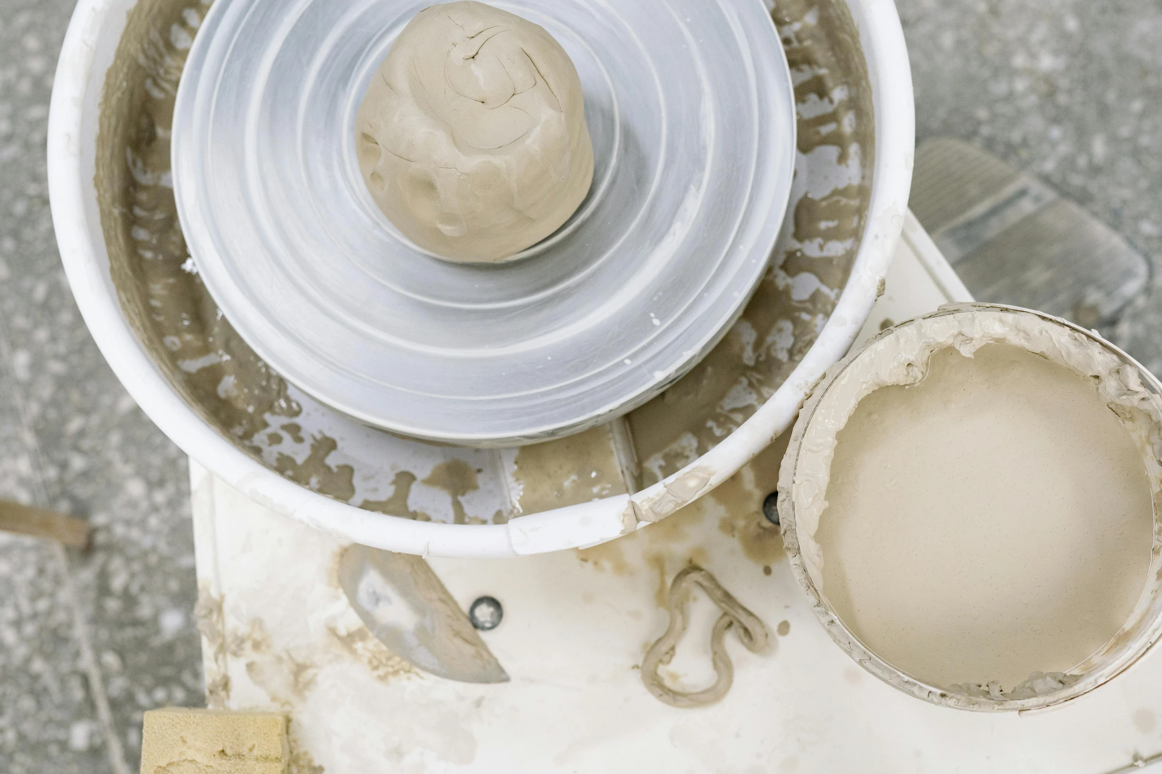 a close up of a bowl on a potter's wheel, a marble sculpture, inspired by Sarah Lucas, trending on unsplash, process art, promo image, birdseye view, unfinished, thumbnail