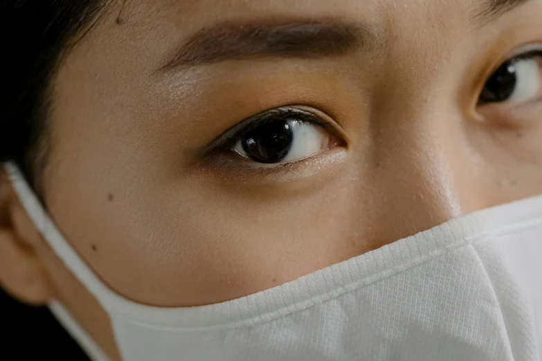 a close up of a person wearing a face mask, trending on pexels, asian girl, white around right eye, full body extreme closeup, surgeon