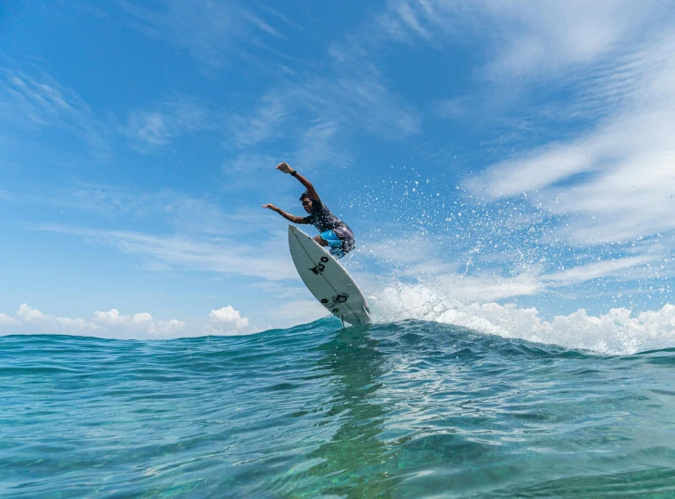 a man riding a surfboard on top of a wave, great barrier reef, deus ex machina, pristine and clean, take off