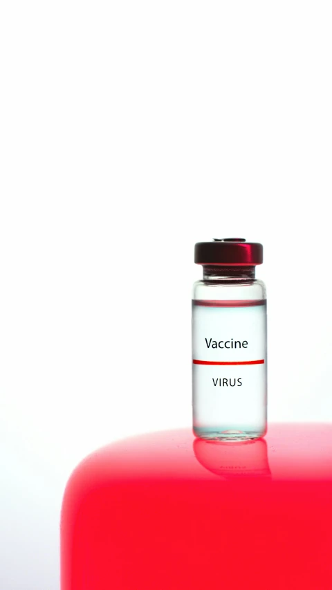 a bottle of vaccine sitting on top of a red stool, by Nicolette Macnamara, shutterstock, square, beauty is a virus, 188216907, medical equipment