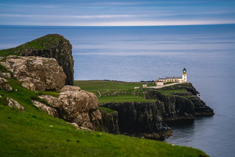 a lighthouse sitting on top of a cliff next to the ocean, skye meaker, nature photo