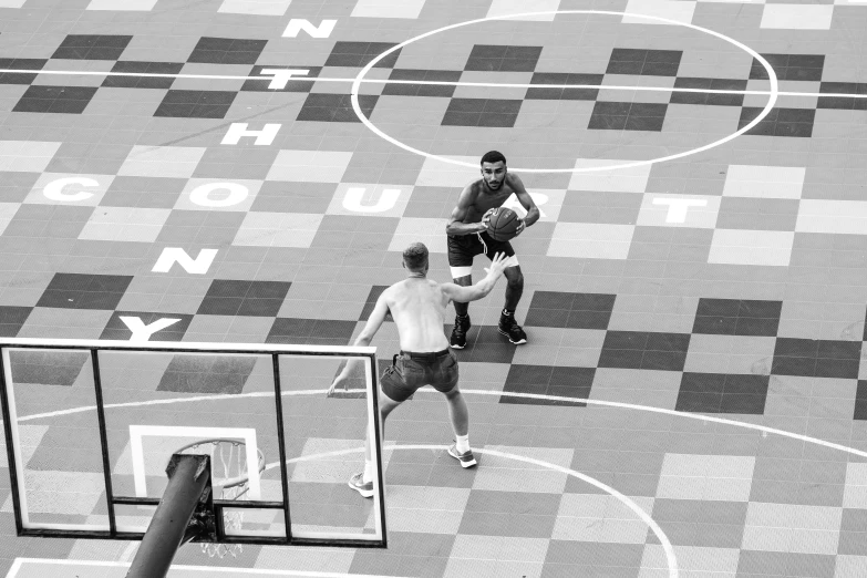 a couple of men standing on top of a basketball court, a black and white photo, trending on dribble, squares, a high angle shot, hunting, in - game