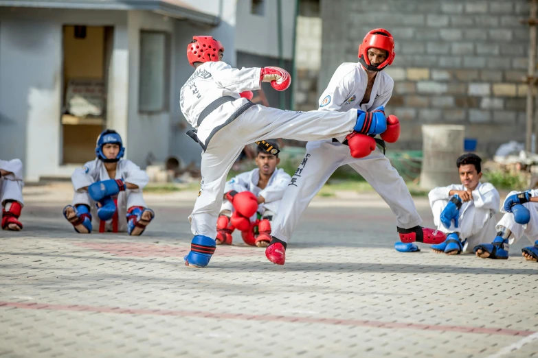 a couple of men standing next to each other on a street, pexels contest winner, bengal school of art, karate kick, panoramic shot, action shots, mid action