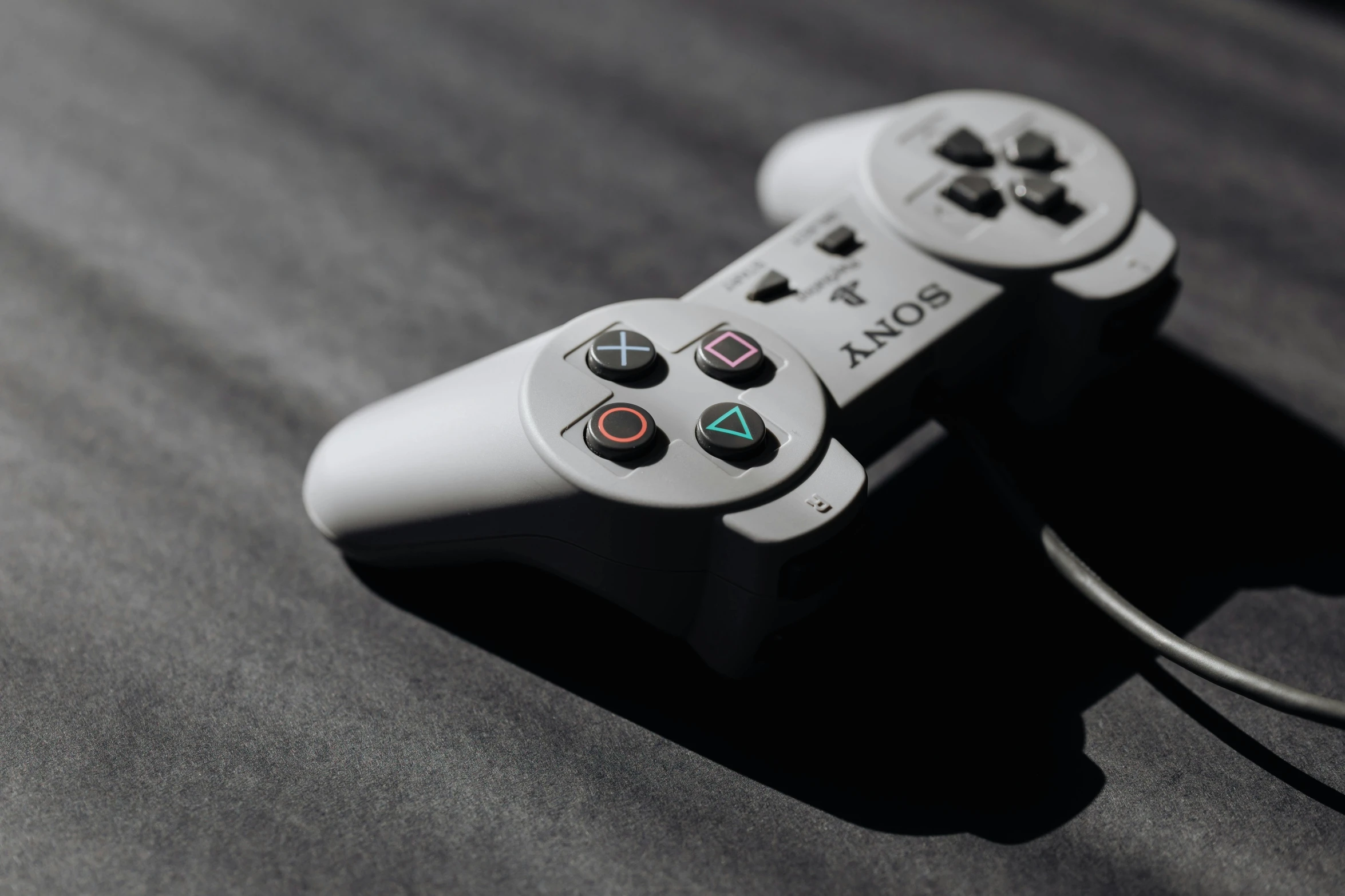 a close up of a video game controller, unsplash, hyperrealism, square enix, playstation 1 game, dark and white, contain