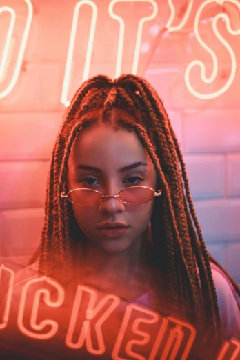a woman standing in front of a neon sign, an album cover, inspired by Elsa Bleda, trending on pexels, renaissance, cornrows braids, wearing red tainted glasses, portrait of vanessa morgan, lesbians