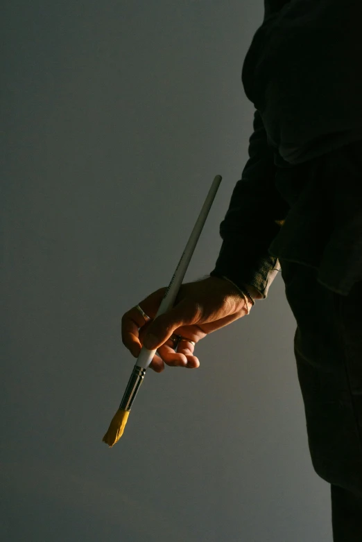 a man in a suit holding a baseball bat, a photorealistic painting, inspired by Jan Rustem, unsplash, hyperrealism, chopsticks, ( low key light ), holding paintbrushes, minimalist photorealist