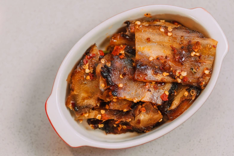 a close up of a bowl of food on a table, fins, sticky, spicy, 1x