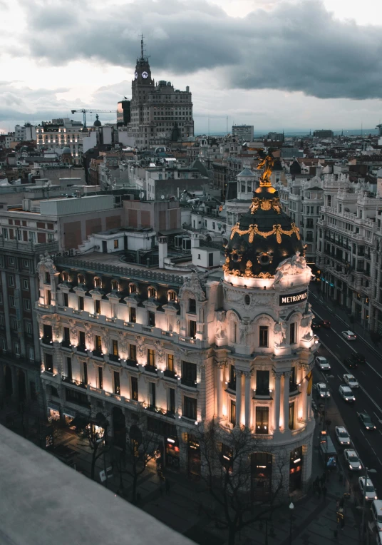 a view of a city from the top of a building, inspired by Tomàs Barceló, unsplash contest winner, art nouveau, 2 5 6 x 2 5 6 pixels, madrid, evening lights, slide show