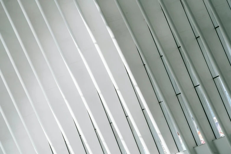 a man sitting on a bench in front of a wall, inspired by Ryoji Ikeda, unsplash, light and space, office ceiling panels, macro up view metallic, white steel, spines