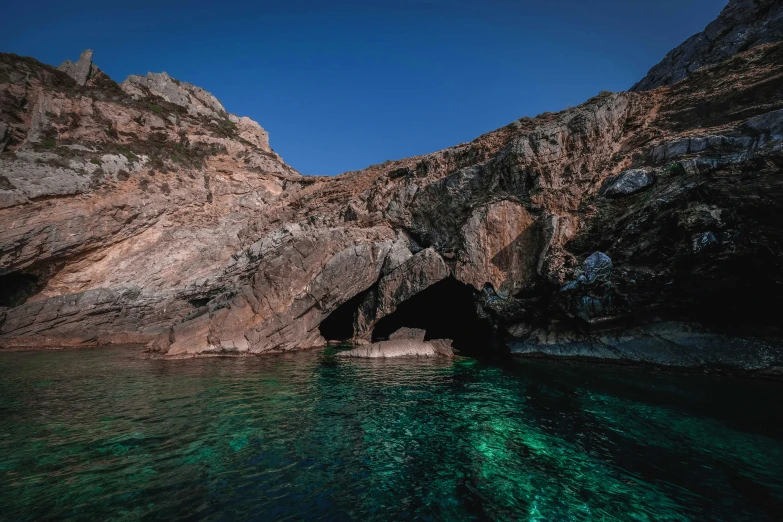 a cave in the middle of a body of water, by Giuseppe Avanzi, unsplash contest winner, les nabis, traditional corsican, pembrokeshire, slide show, thumbnail