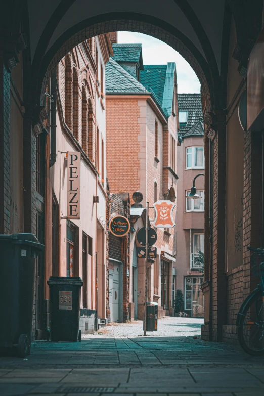 a bicycle is parked in a narrow alley, pexels contest winner, renaissance, road street signs, detmold, black and terracotta, dry archways and spires